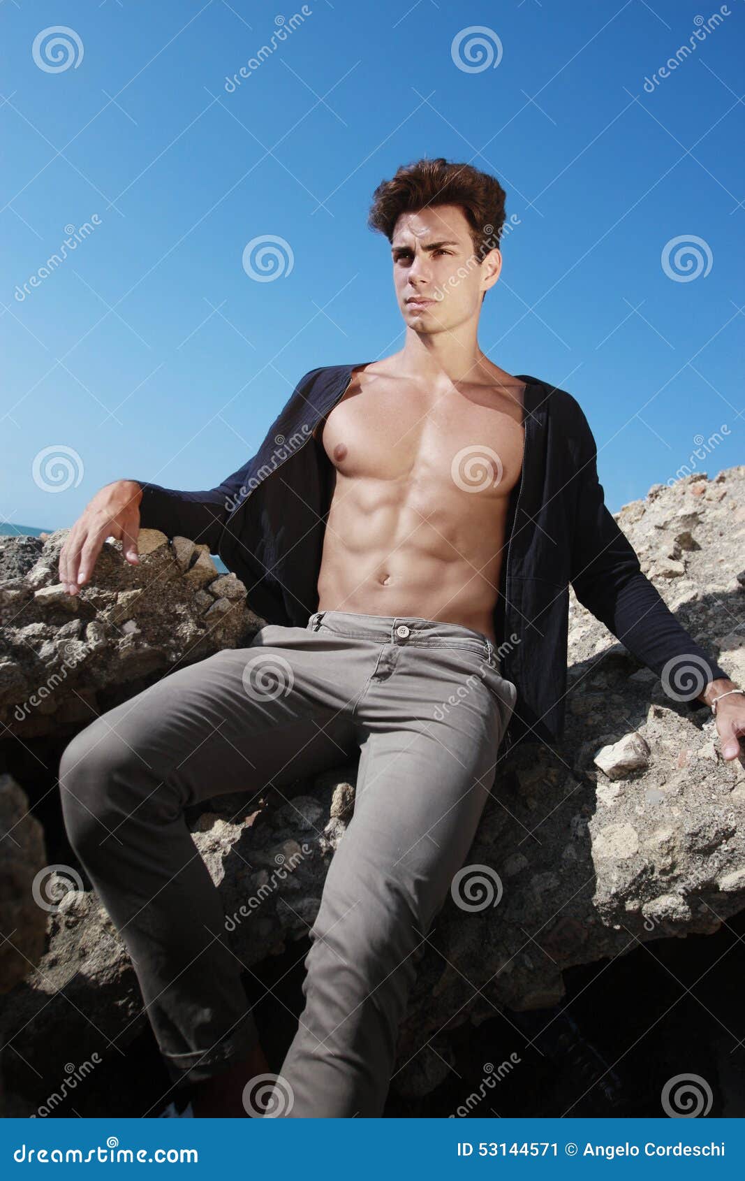 Outfit Young Man. Open Shirt And Muscular Body. On The Outfit Young Man. Open Shirt And Muscular Body. On The