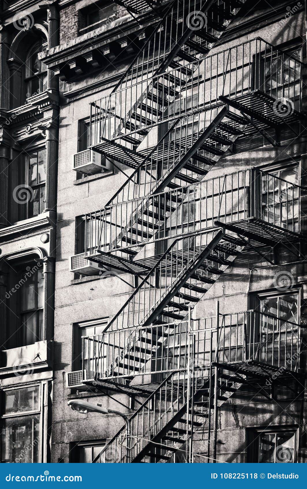 outside metal fire escape stairs, new york city black and white