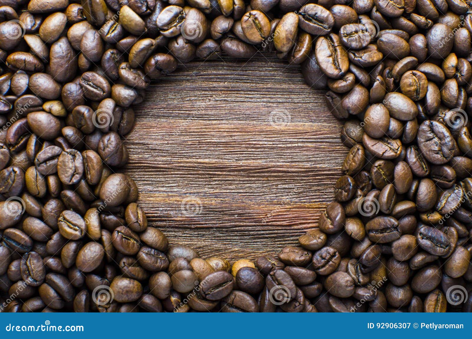 oval of coffee beans on a wooden fone