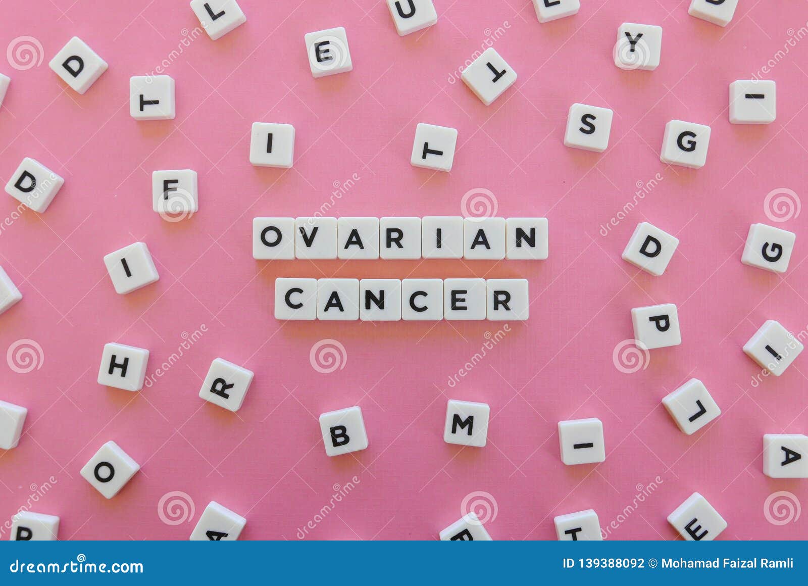 ovarian cancer word made of square letter word on pink background.