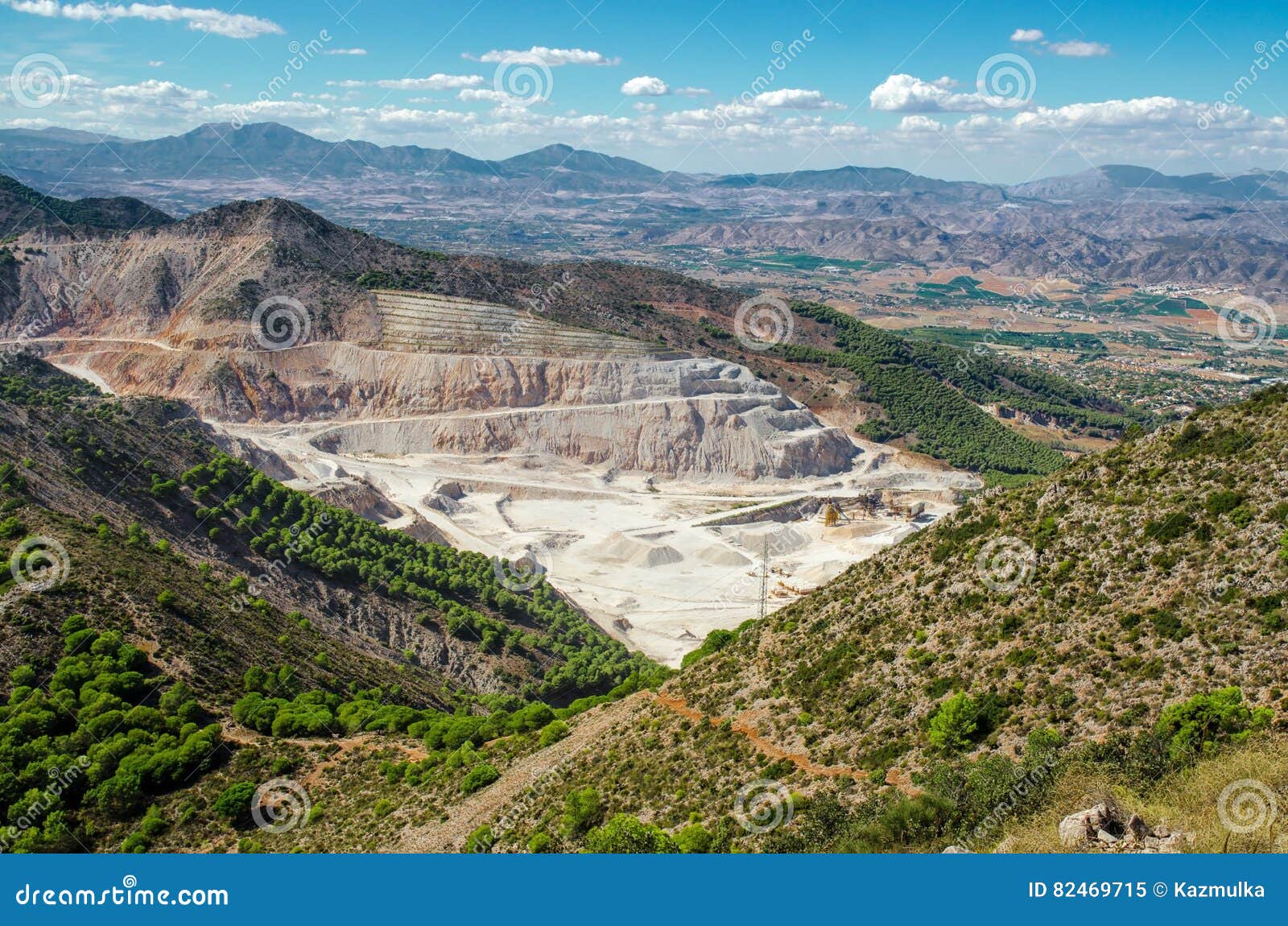 overall view of limestone quarry near calamorro mountain and benalmadena town, andalusia, southern spain.
