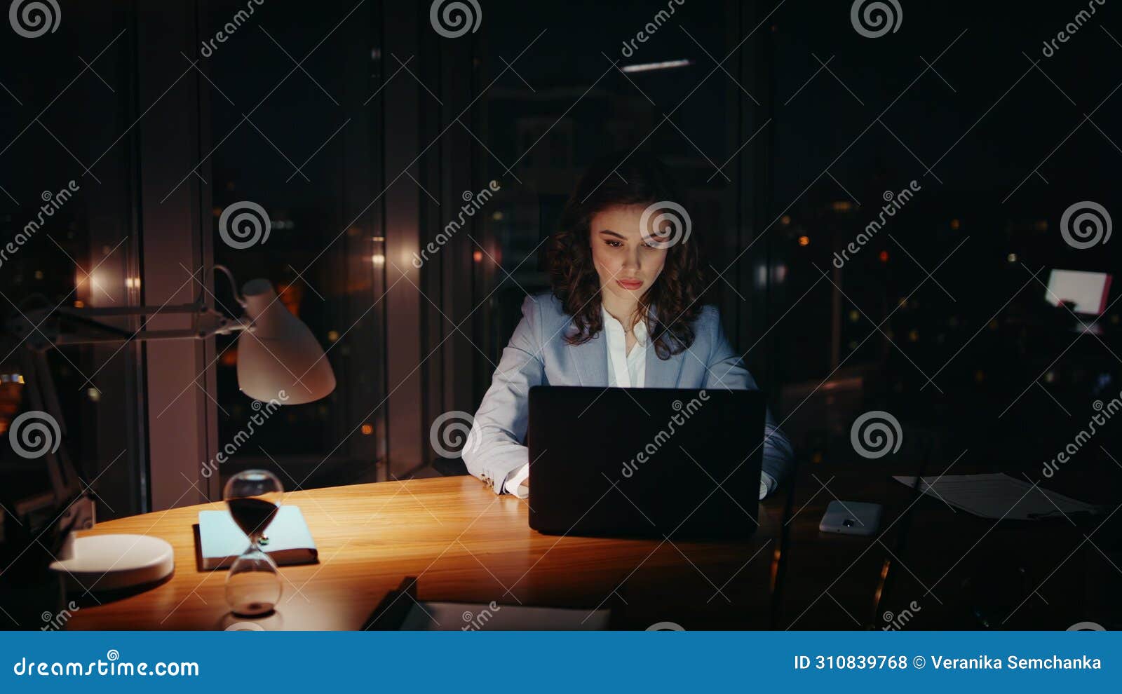 overburdened woman working office closing tired eyes looking laptop at night.