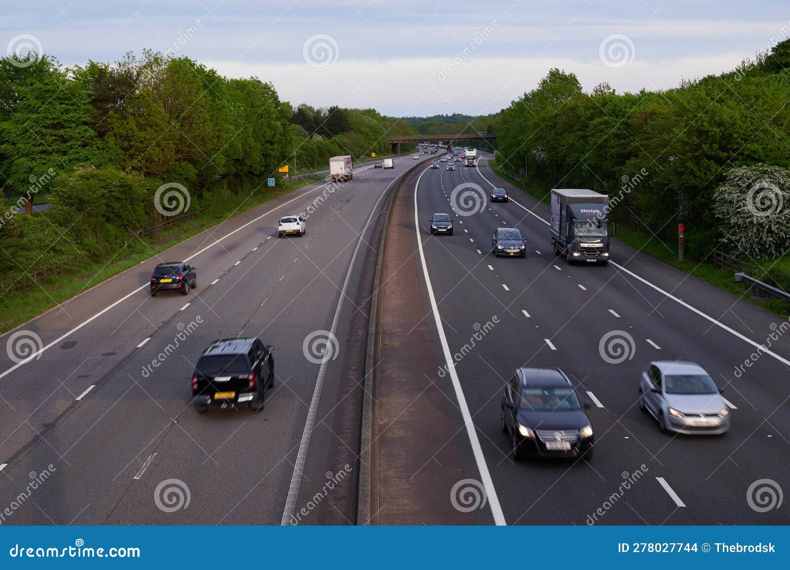 Overhead Image of Three Lane Motorway in Daylight with Motion Blur of