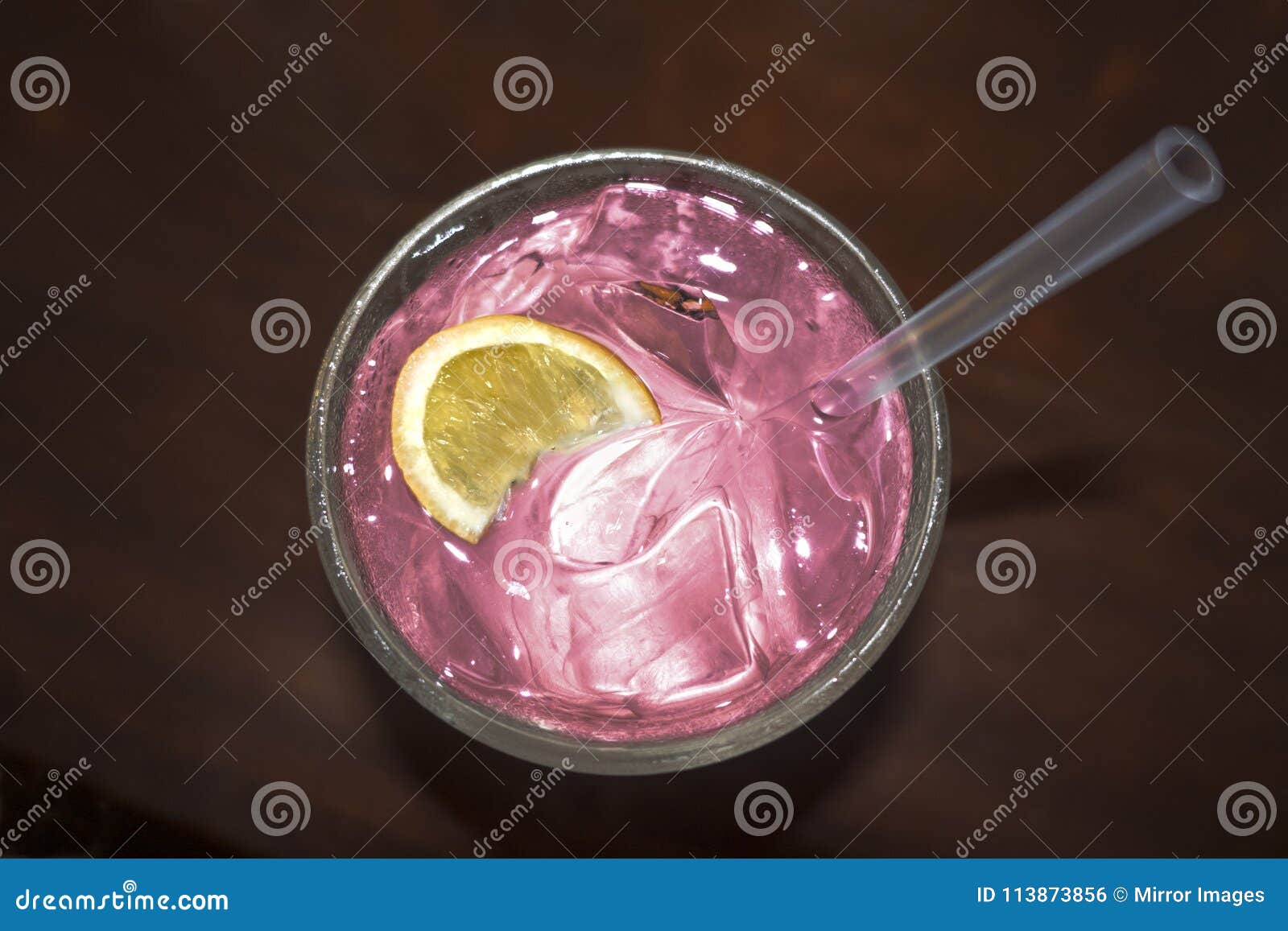 cocktail drink with lemon silice pink liquid