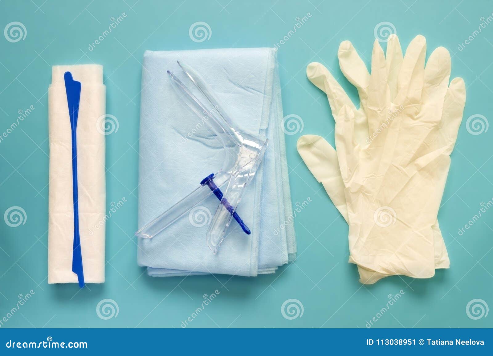 an overhead photo of the vaginal speculum, napkin, medicine gloves and spatula. the medical tools for holding open the vagina duri