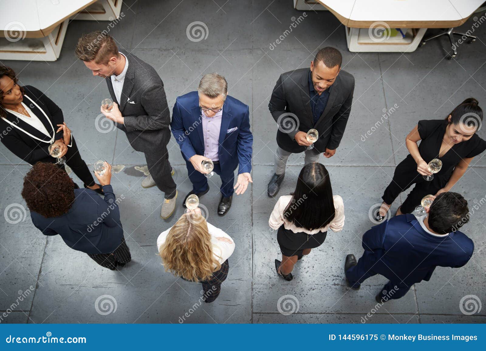overhead shot of business team socializing at after works drinks in modern office