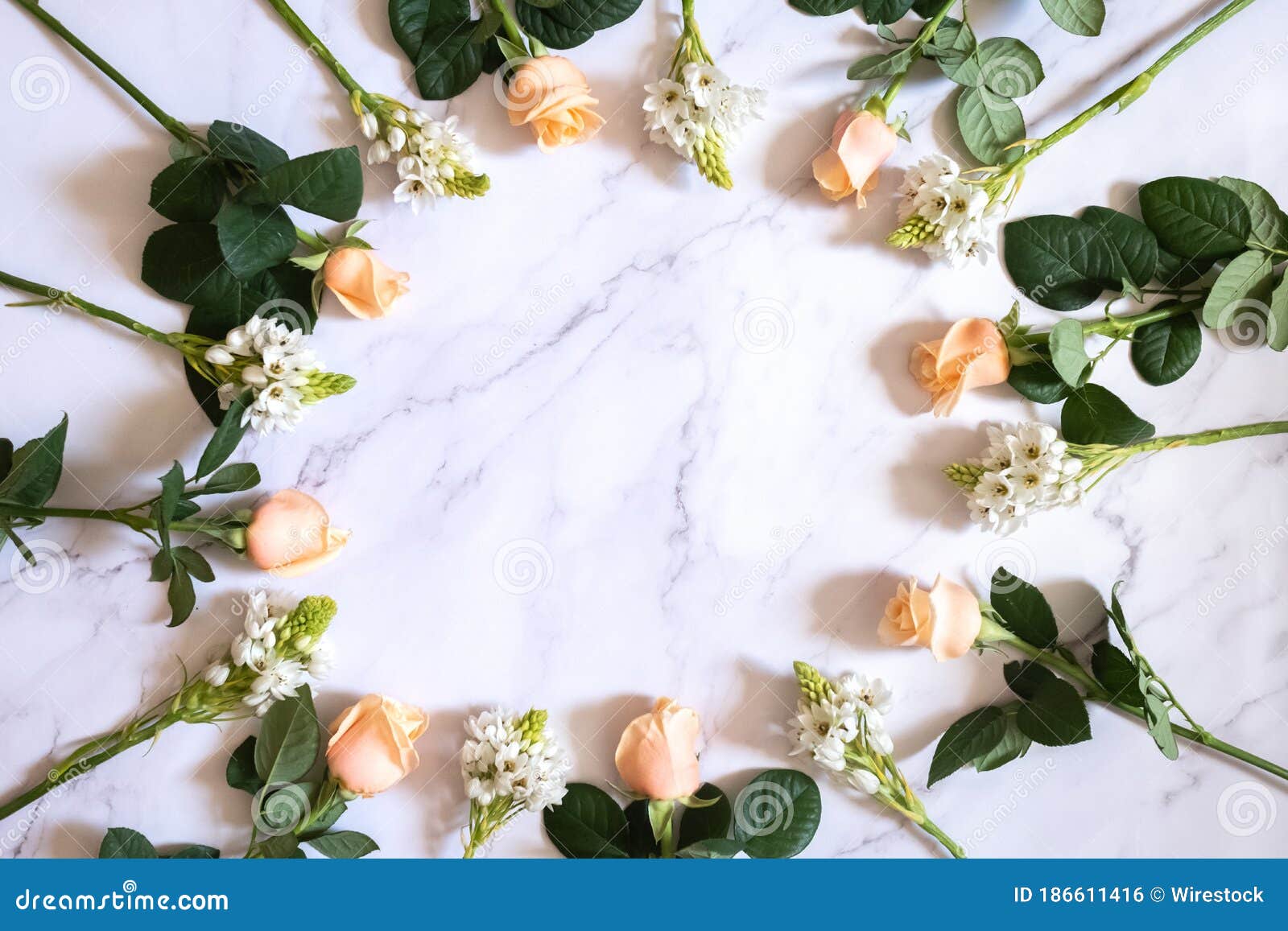 Overhead Shot of Garden Roses and White Small Flowers Laying on a White ...