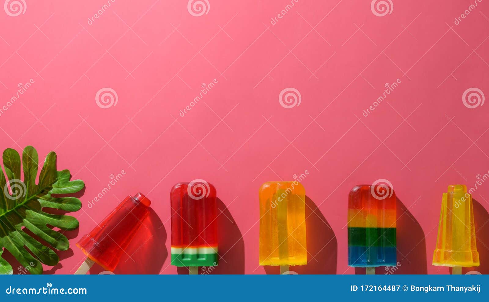 Overhead Shot of Minimal Colourful Summer Concept with Popsicles on Red