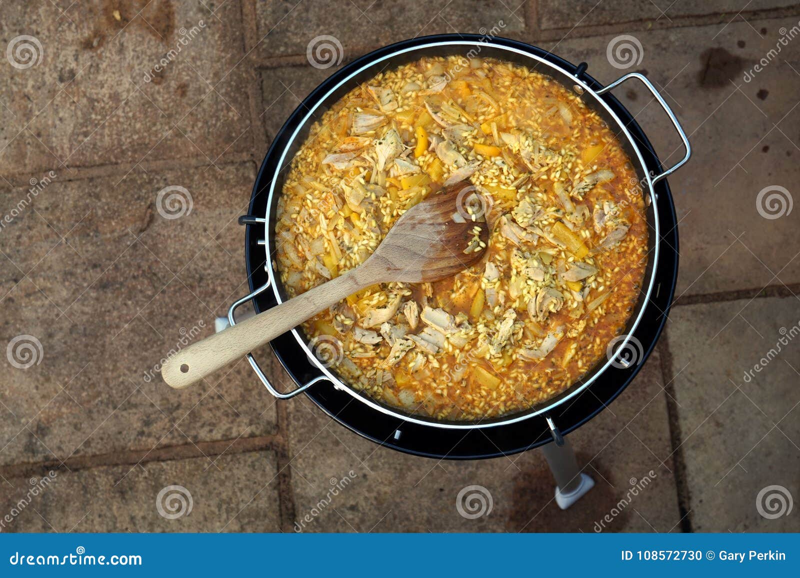Overhead Shot of a Pan of Paella Cooking Outdoors Stock Photo Image