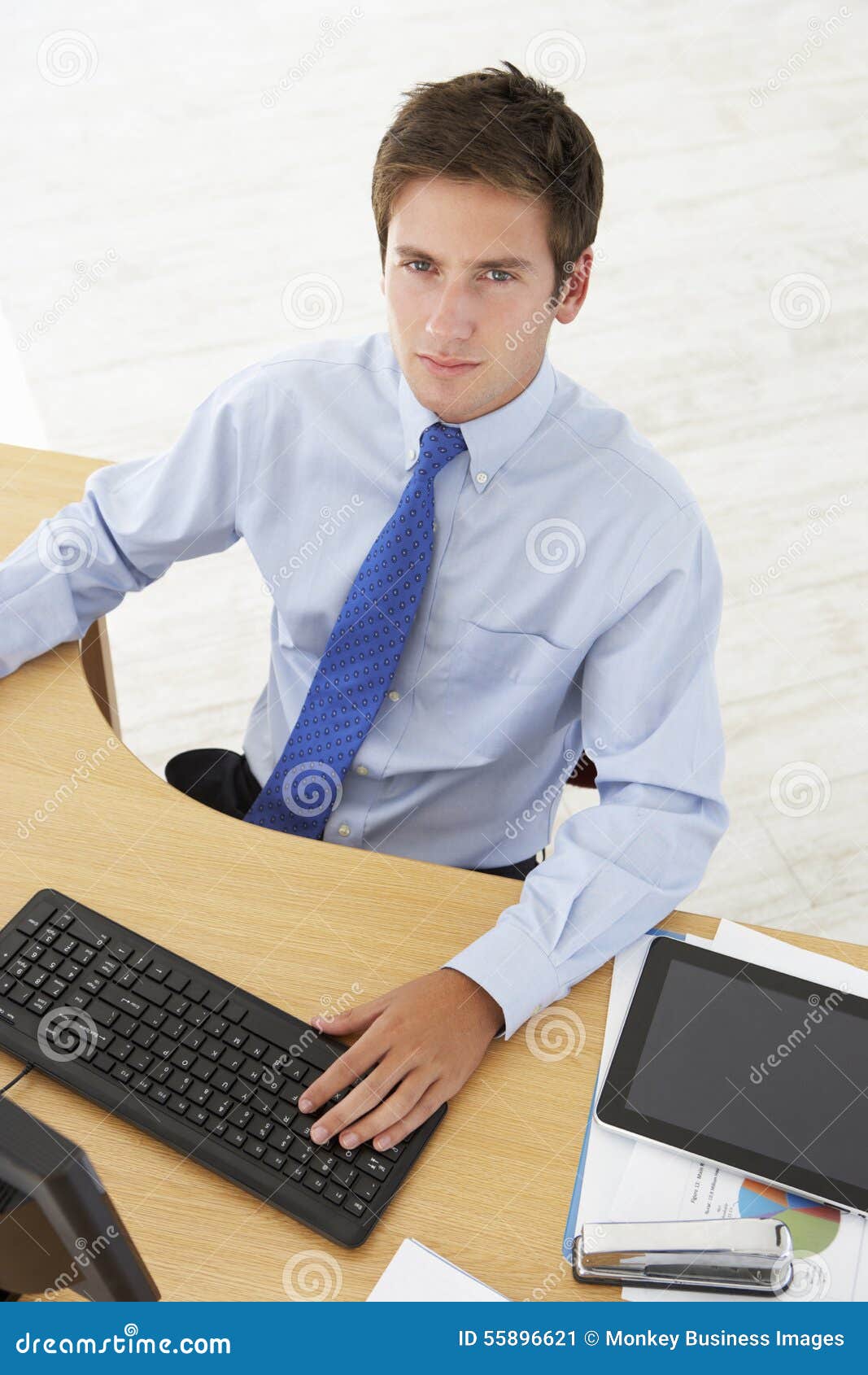 Overhead View of Businessman Working at Desk Using Digital Table Stock