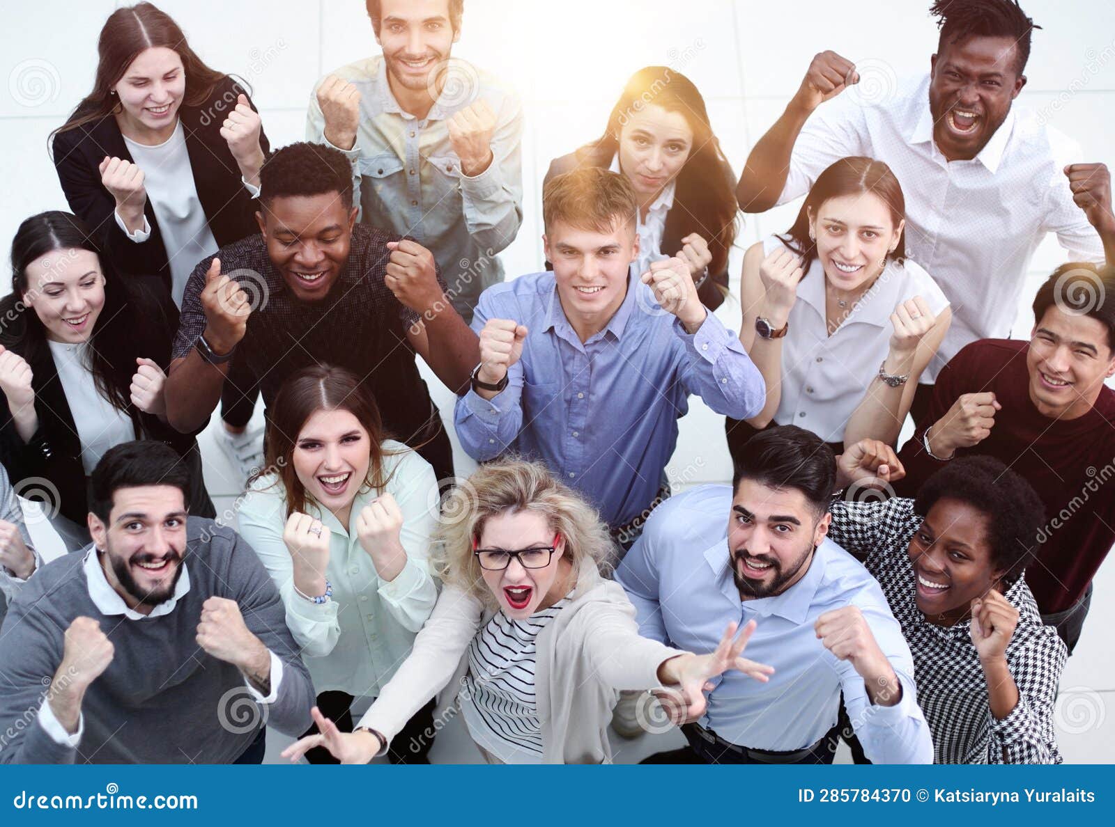 Overhead View of Businesspeople Looking Up and Waving Stock Photo