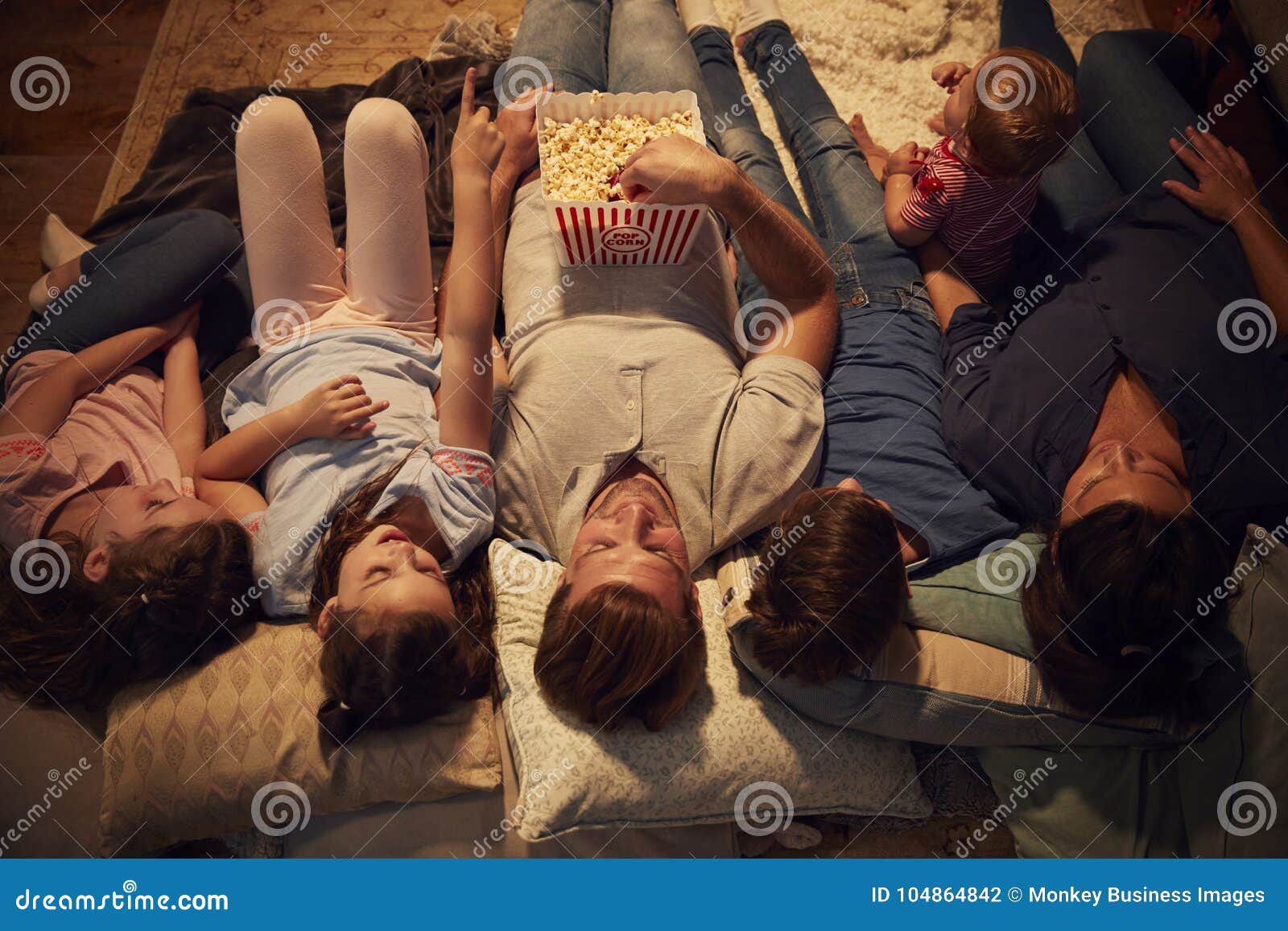 overhead view of family enjoying movie night at home together