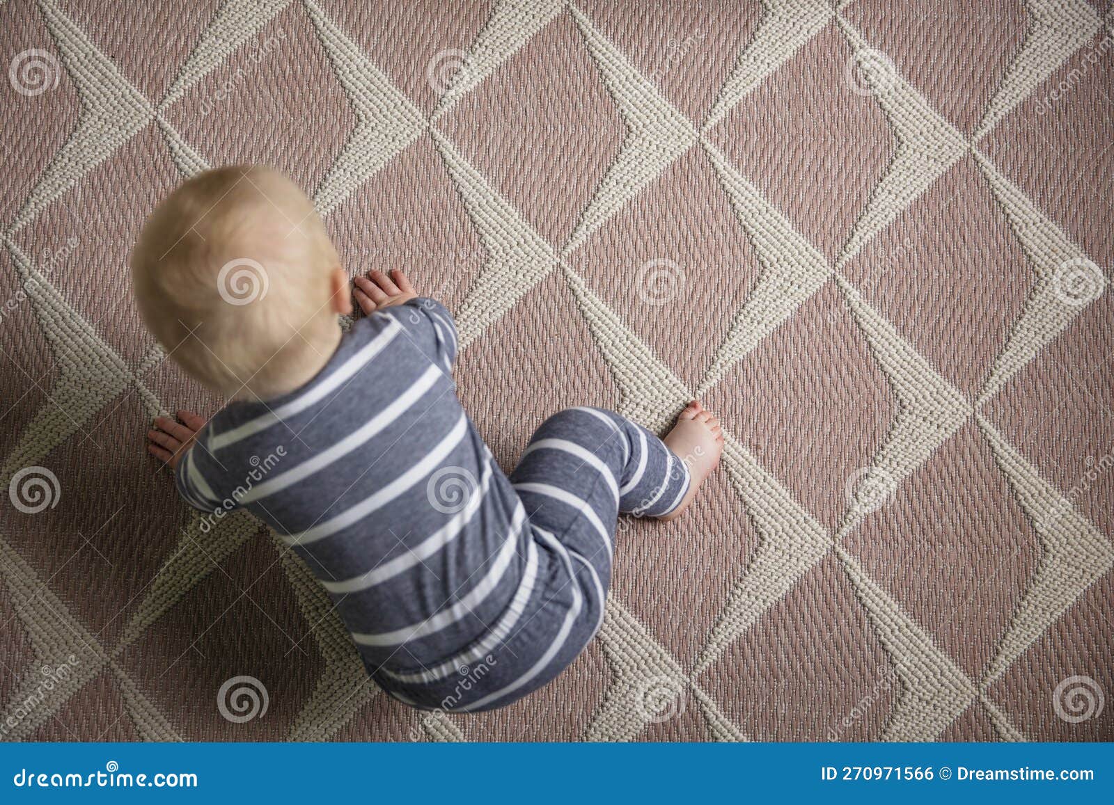 overhead view of a 7 month old baby as they try to crawl for the first time