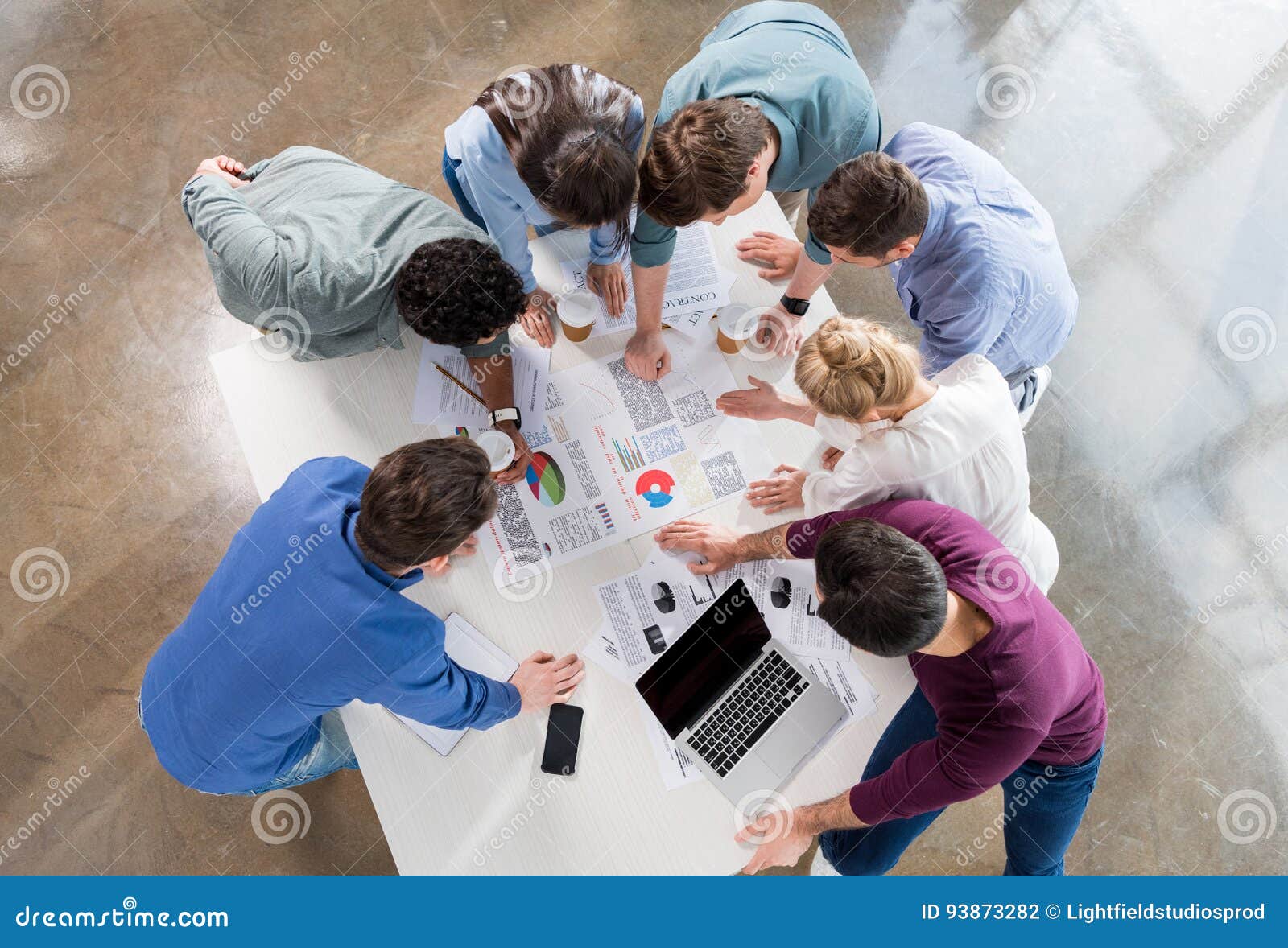 overhead view of professional businesspeople discussing and brainstorming together