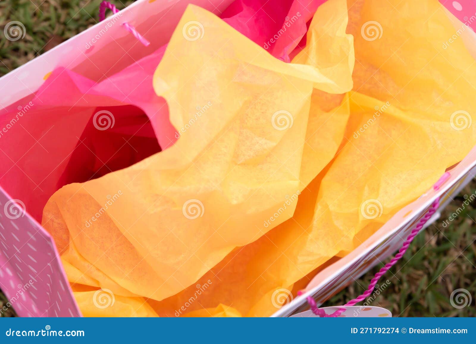 Overhead View of Yellow and Pink Tissue Paper in Gift Bag Stock Photo ...