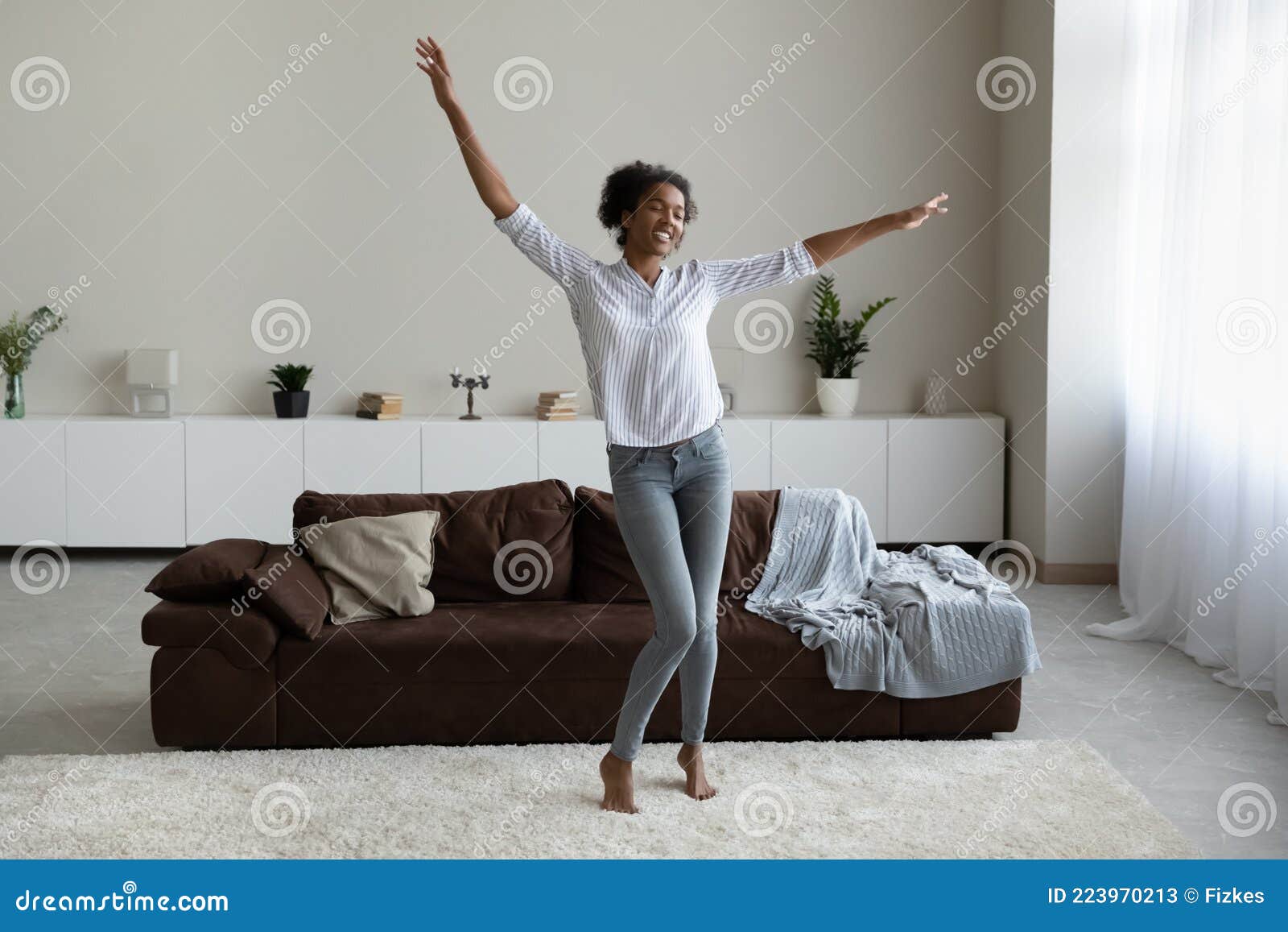 Overjoyed African American Woman Dancing in Modern Living Room Alone ...