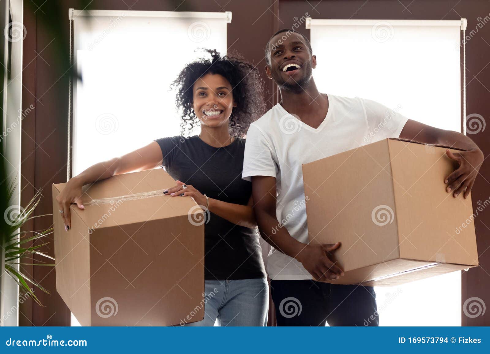 impressed black couple entering new home on moving day