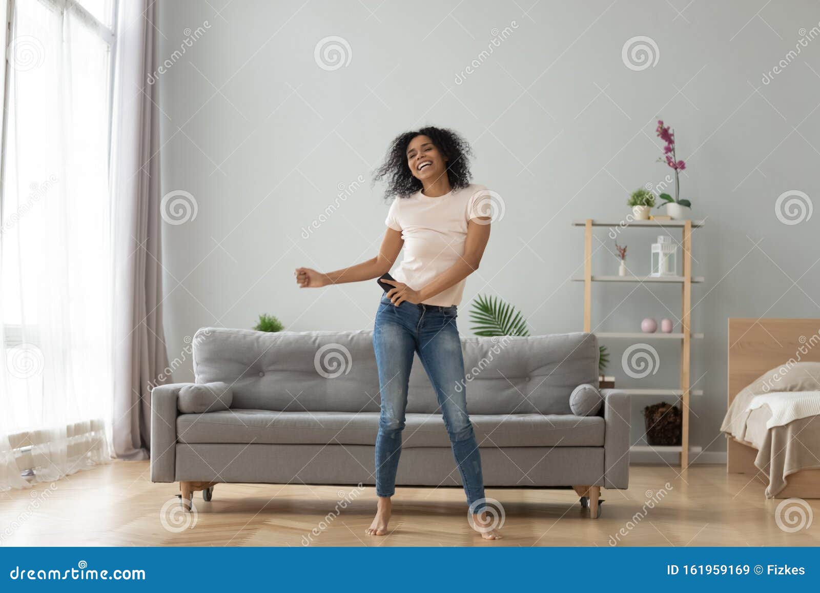 overjoyed black woman have fun dancing at home