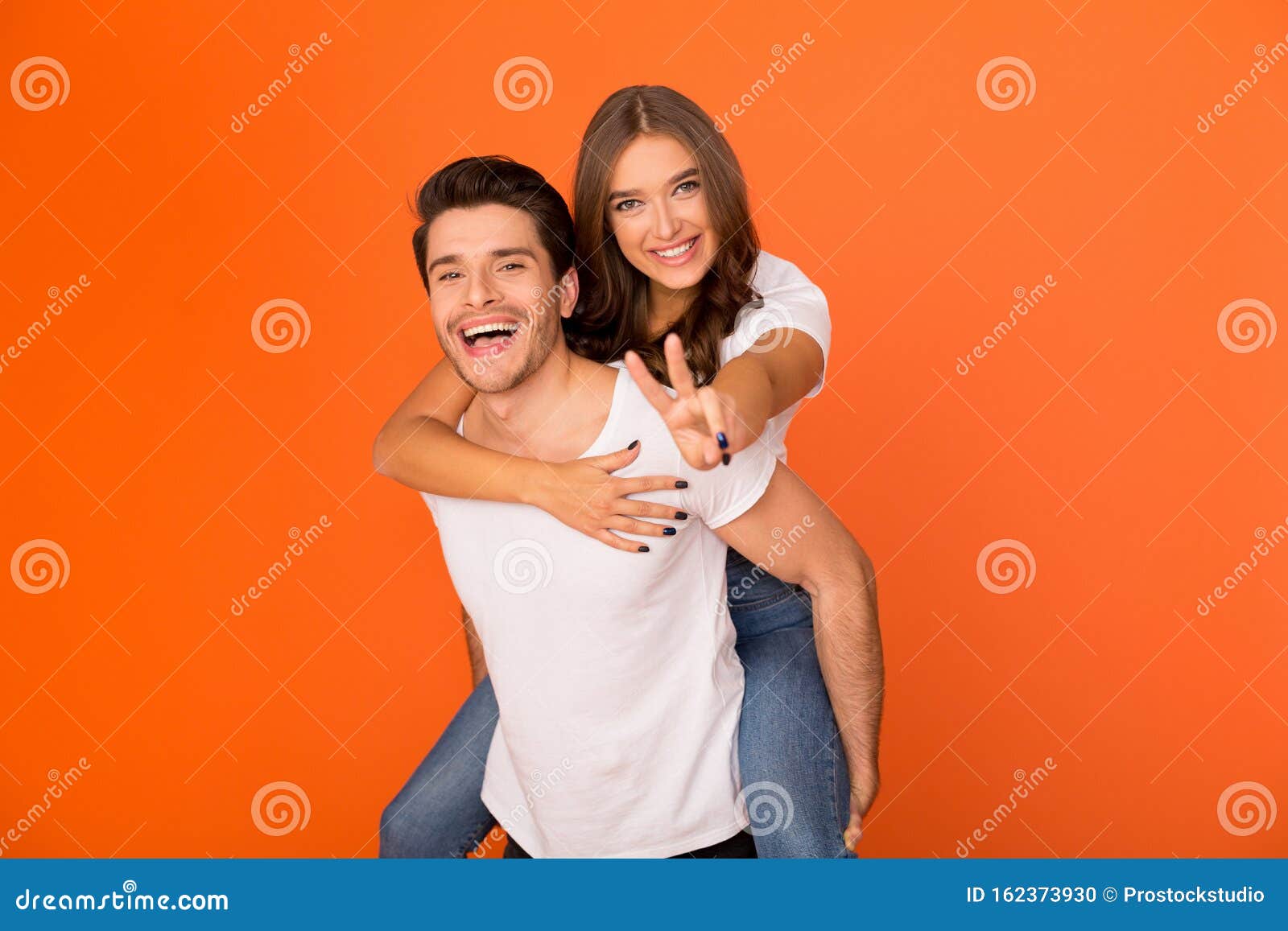Man giving to girlfriend piggyback ride Stock Photo by ©gstockstudio  147713371
