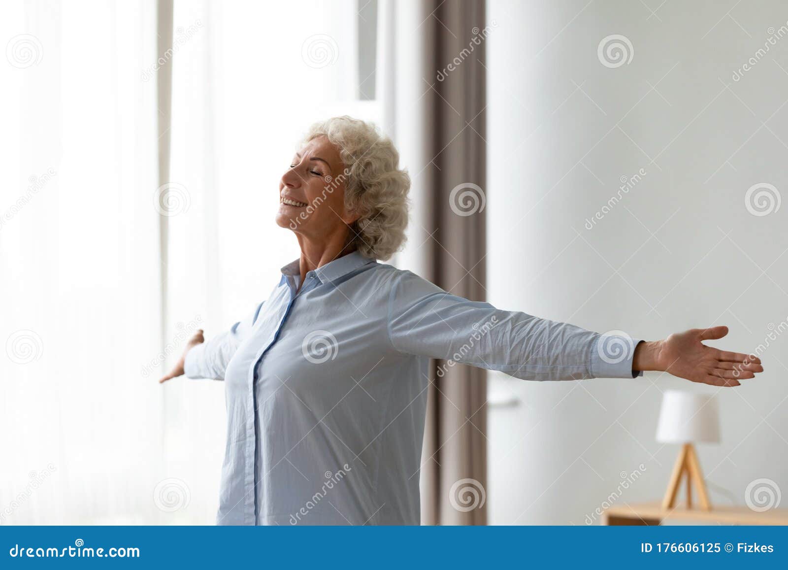 overjoyed old woman stretch at home feeling positive