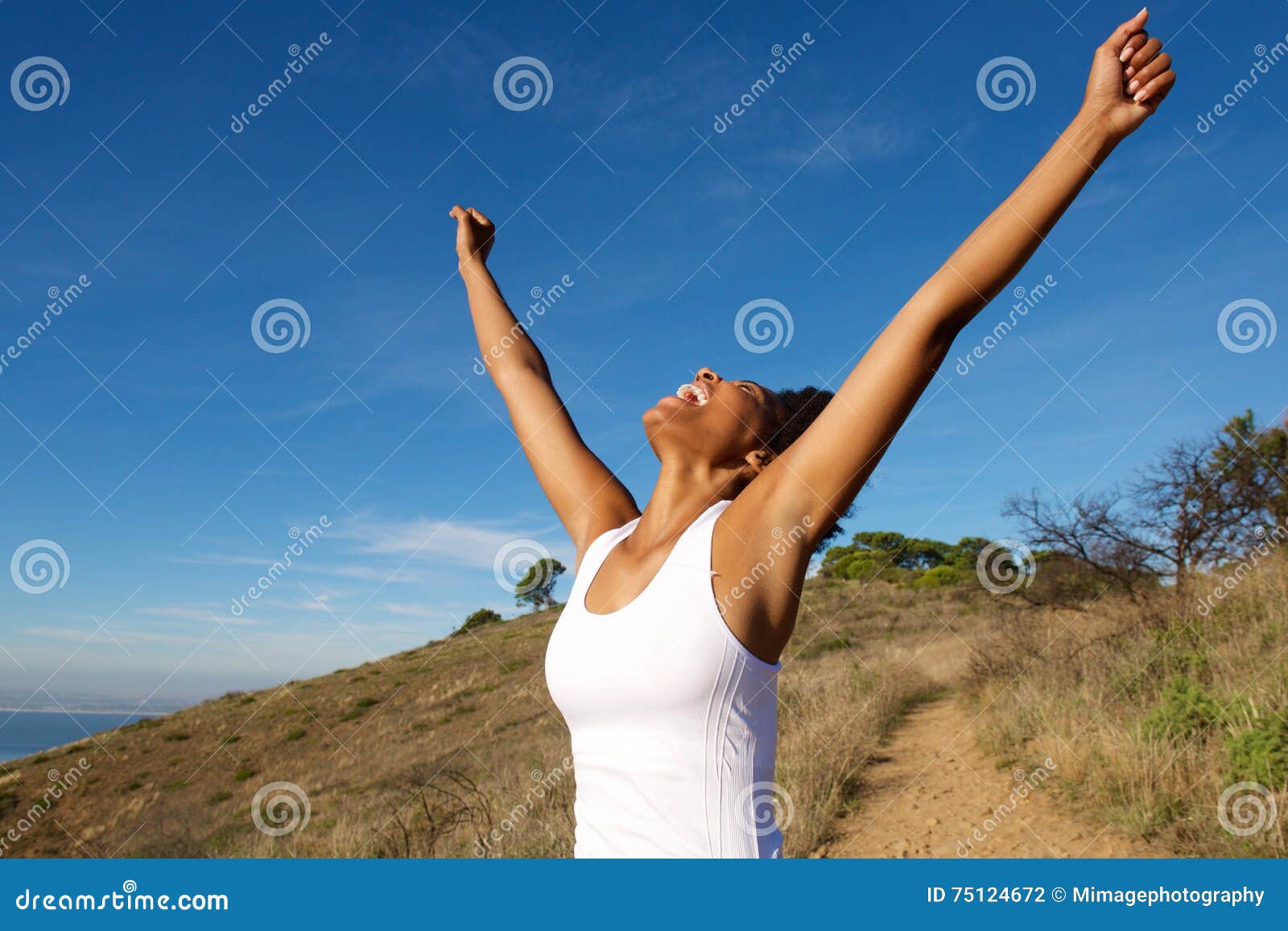 overjoyed woman outdoors with her arms wide open