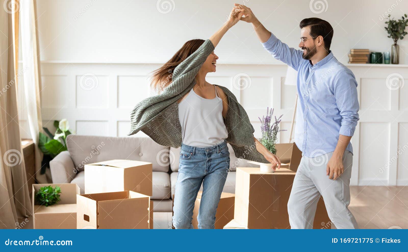 overjoyed couple dance have fun on moving day