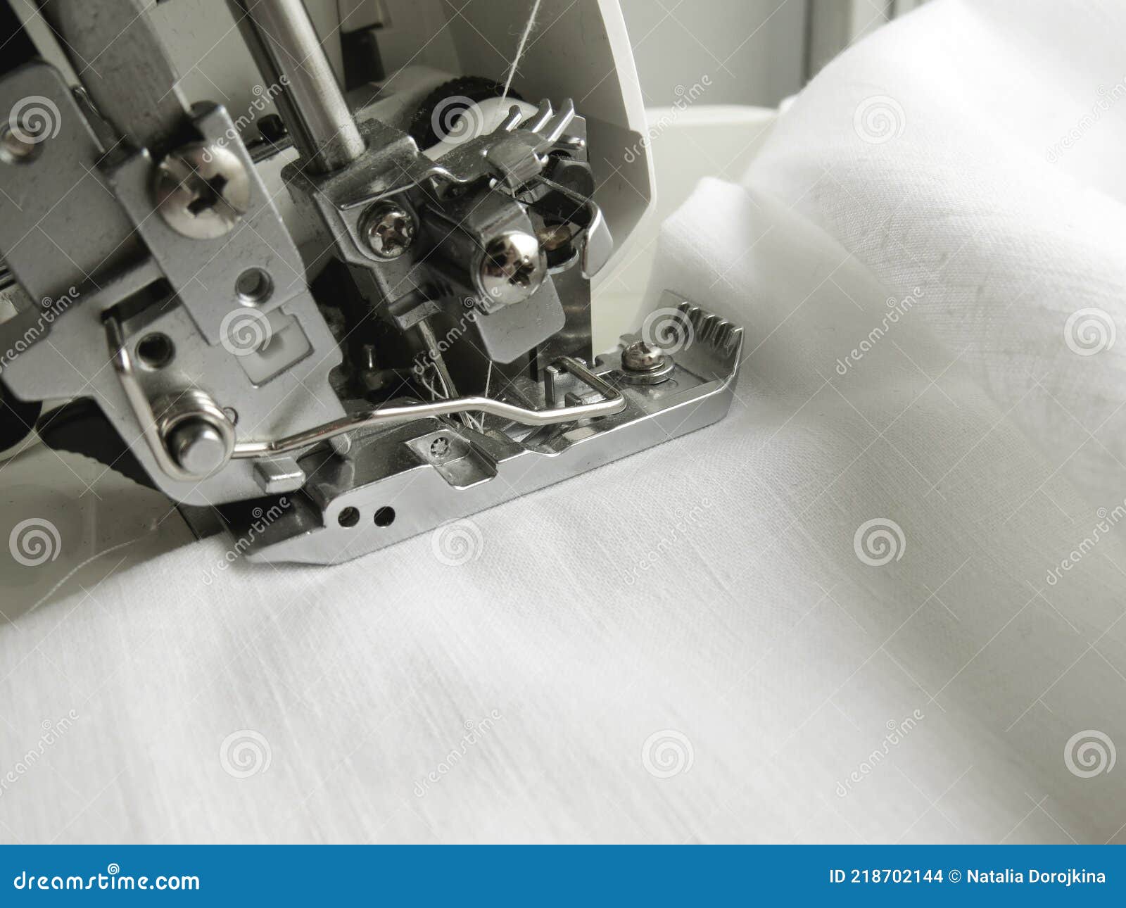The Overlock Sewing Machine Sews White Fabric. Clothing Industry