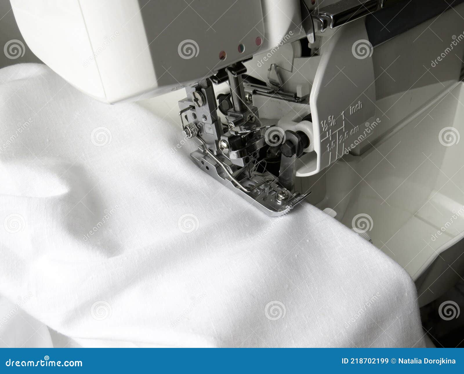 The Overlock Sewing Machine Sews White Fabric. Clothing Industry