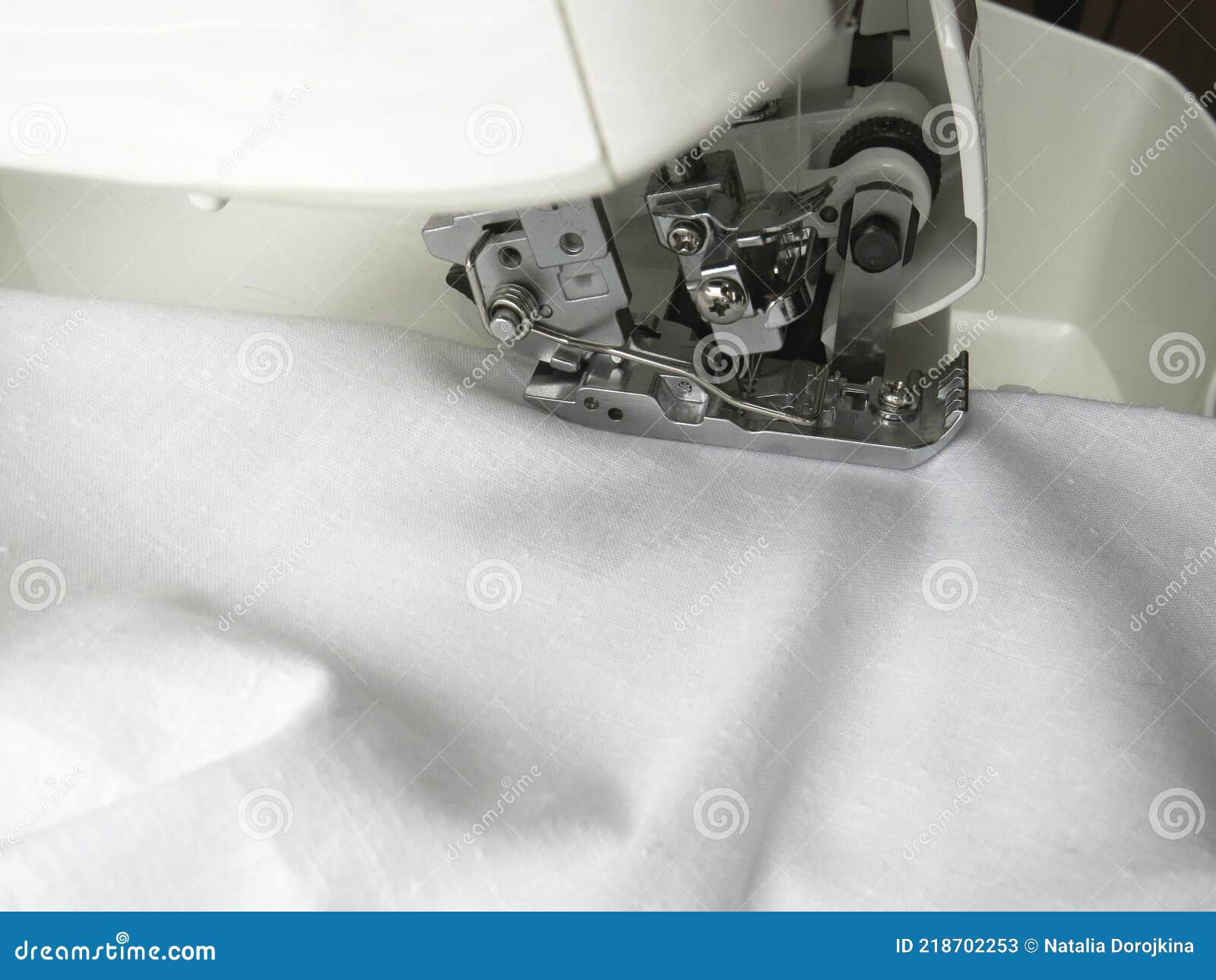 The Overlock Sewing Machine Sews White Fabric. Clothing Industry
