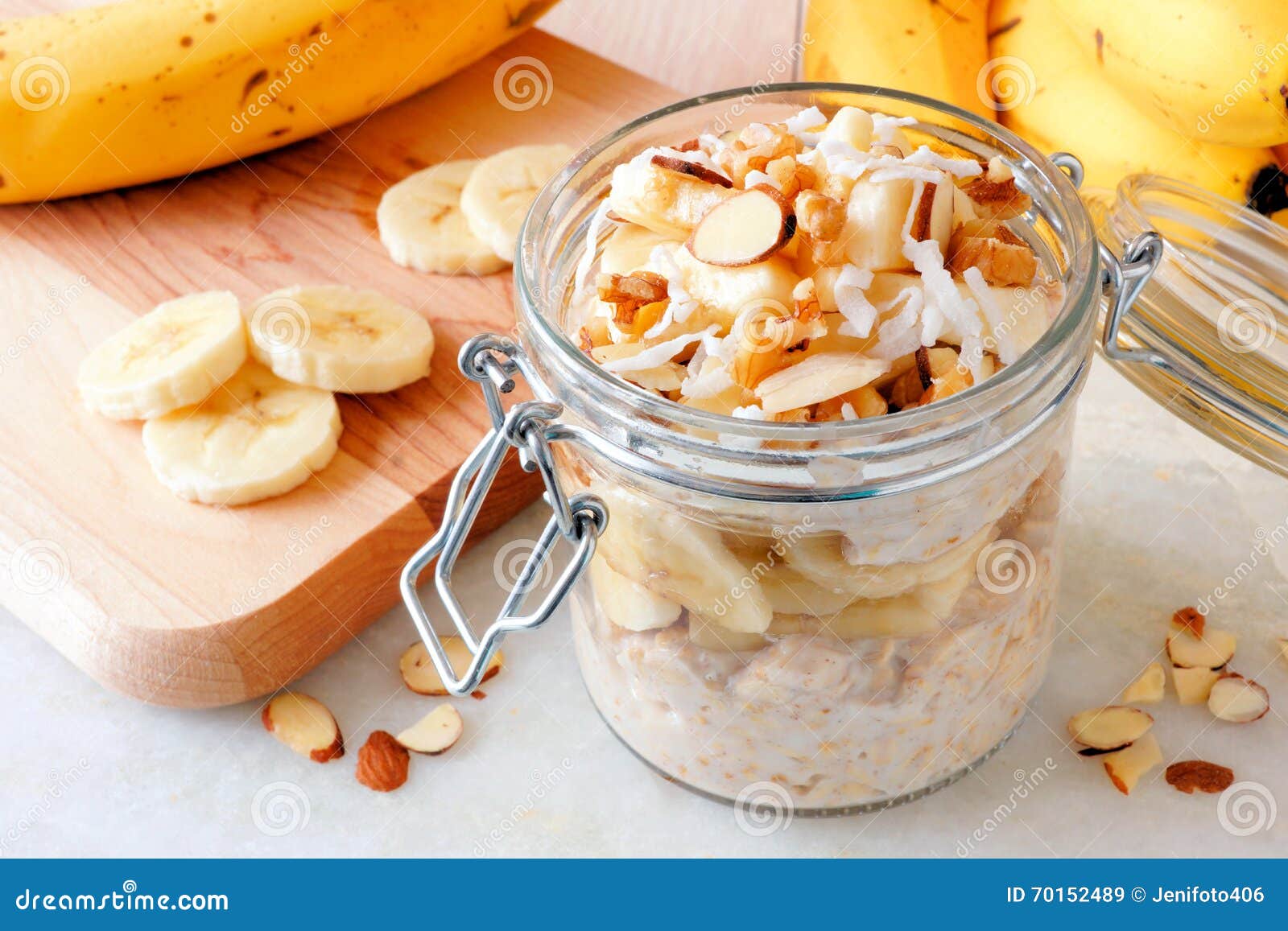 overnight oats with bananas and nuts on white marble