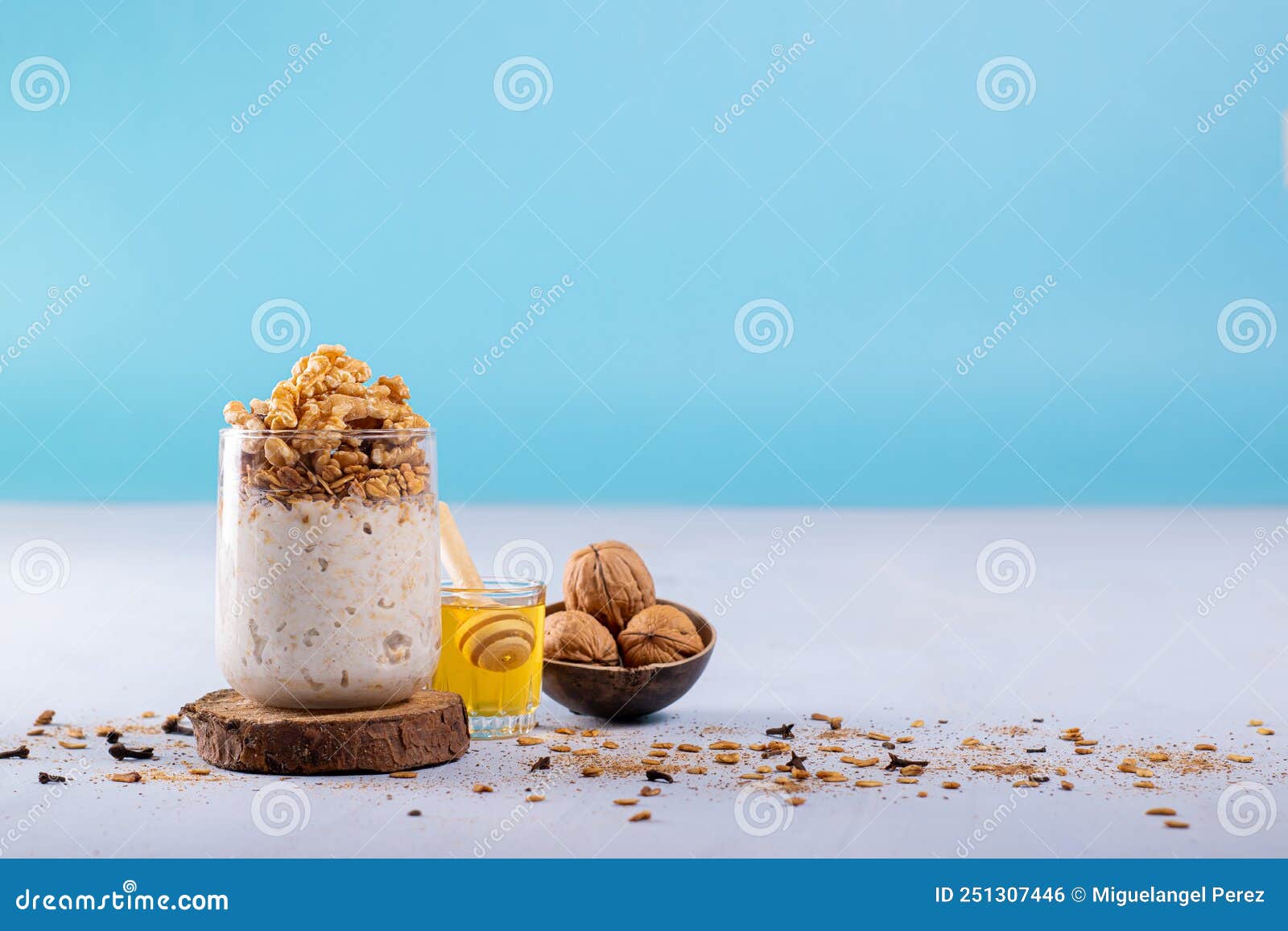 overnight oats with walnuts, accompanied with honey and whole walnuts