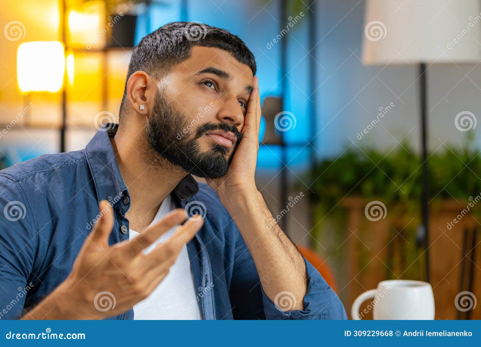 overtired stressed tired indian man freelancer bored with laptop while sitting at home office