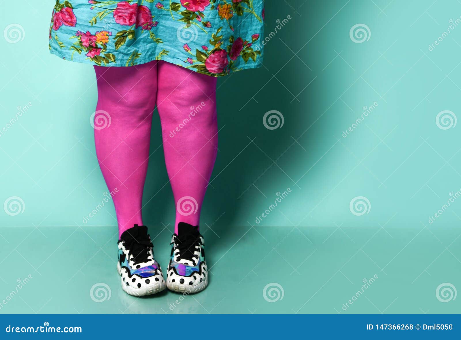 Overweight Fat Woman Legs in Modern Pink Leggings and Sneakers