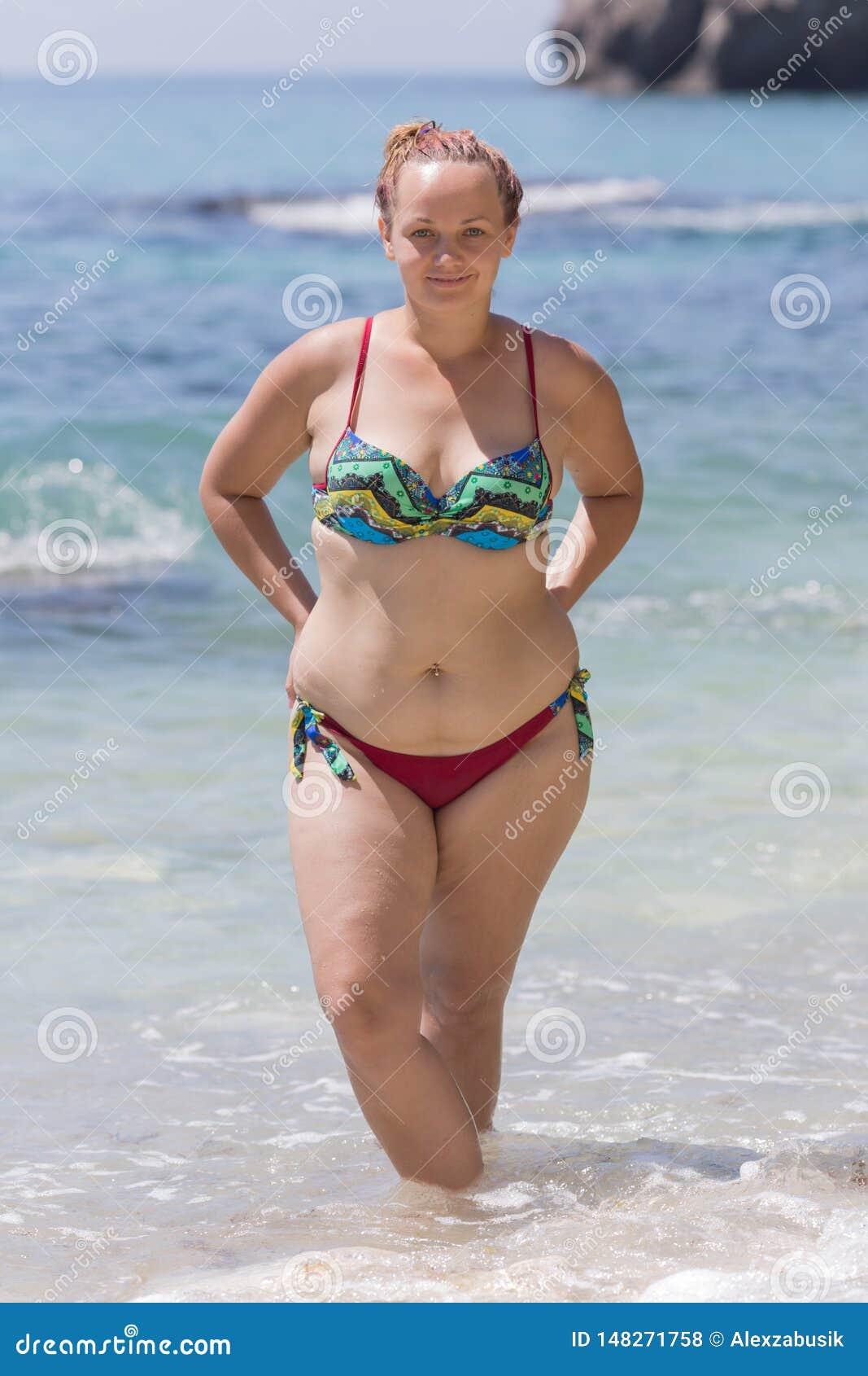 Overweight Female Person in Bikini Posing with Arms Akimbo Stock Photo photo pic image