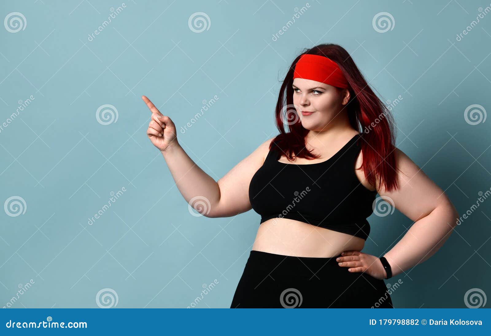 Overweight Redhead Woman in Red Headband, Black Top and Leggings. she ...