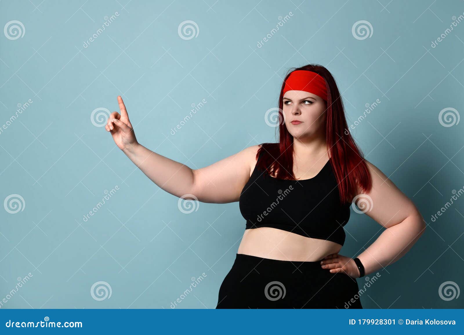 Overweight Redhead Woman in Red Headband, Black Top and Leggings. she ...