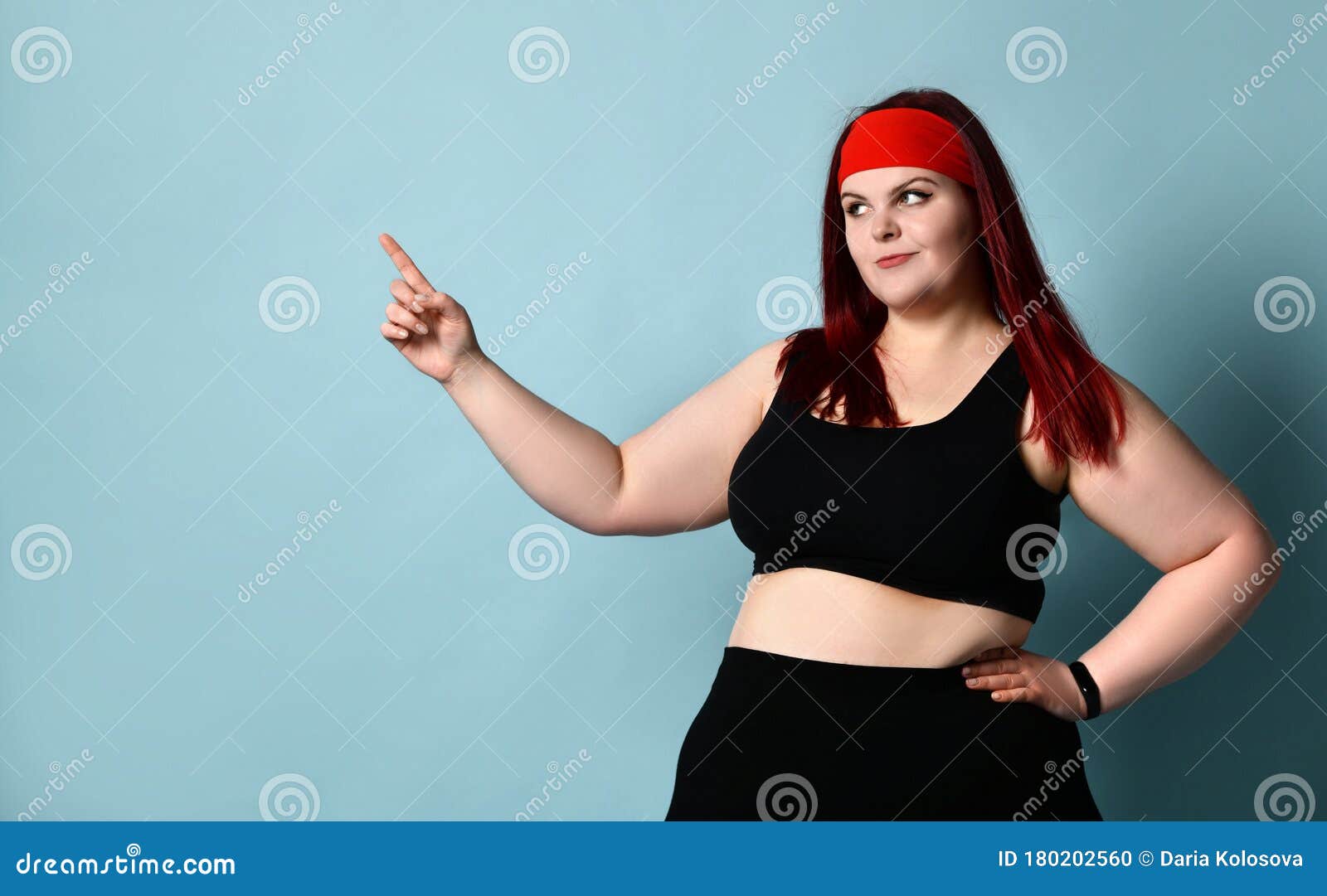 Overweight Redhead Woman in Red Headband, Black Top and Leggings. she ...