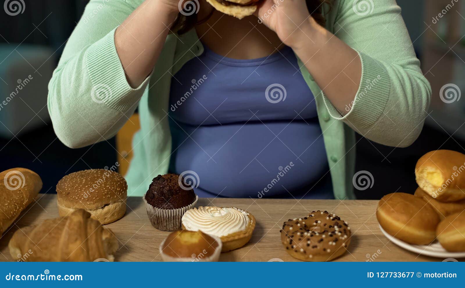 overweight woman consuming too much bakery, eating stress with unhealthy sweets