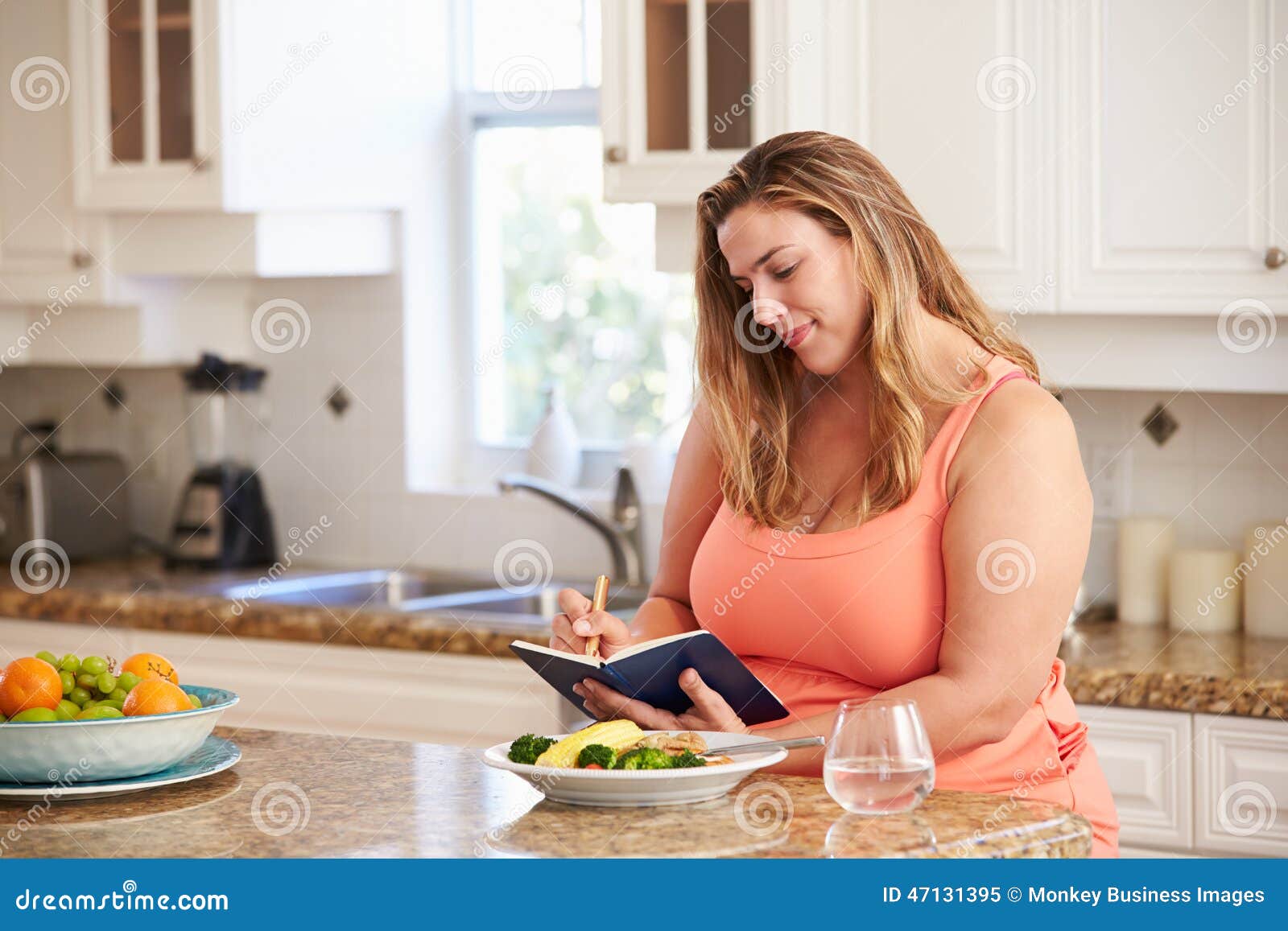 overweight woman on diet keeping food journal