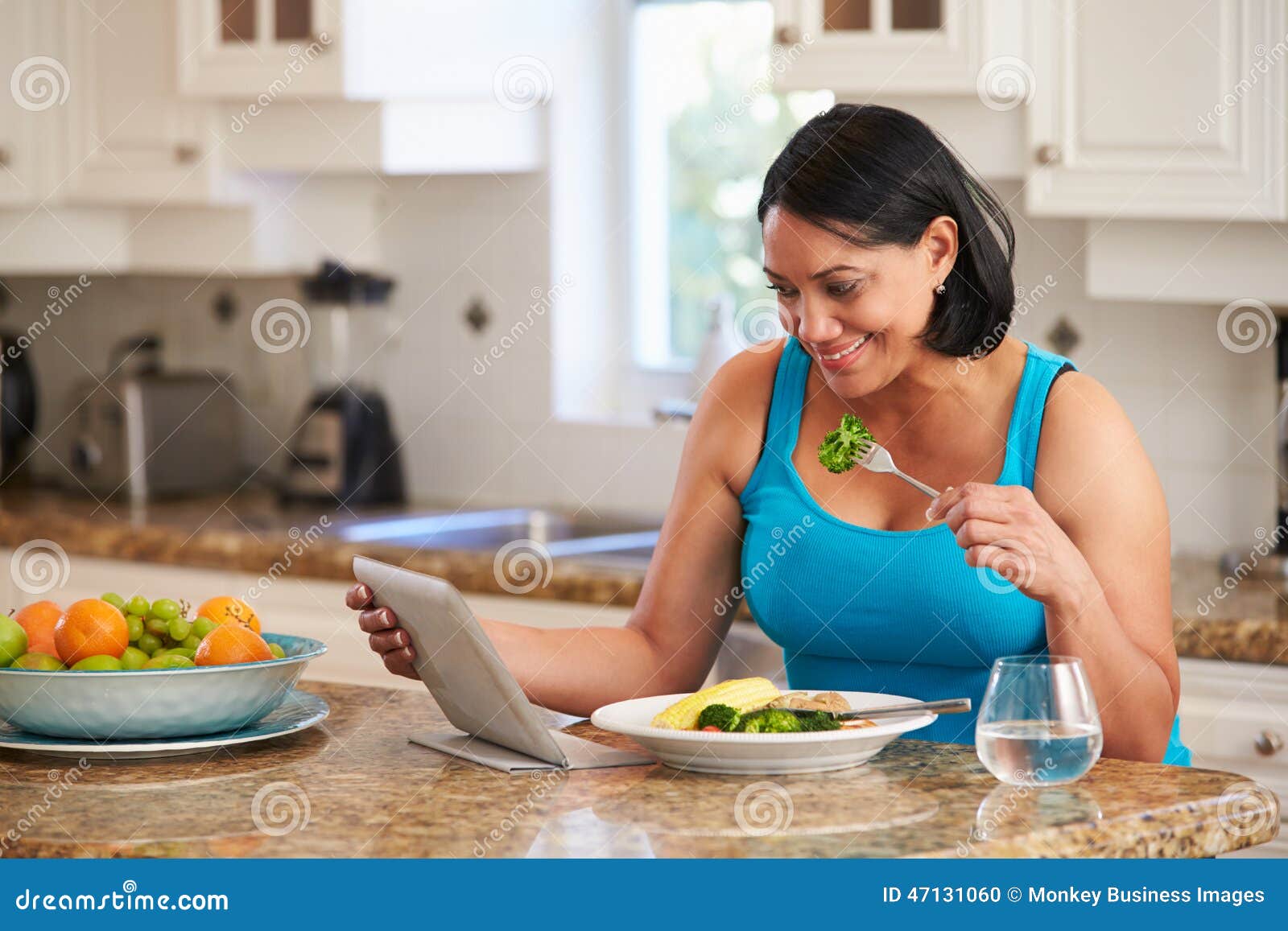 overweight woman with digital tablet checking calorie intake