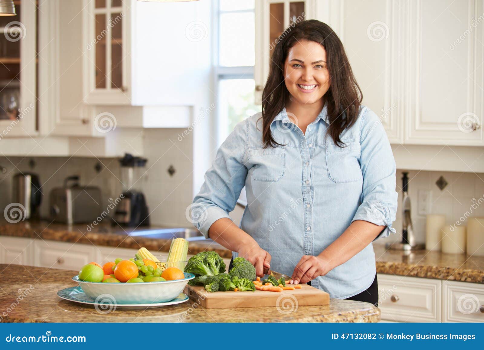 overweight woman preparing vegetables in kitchen