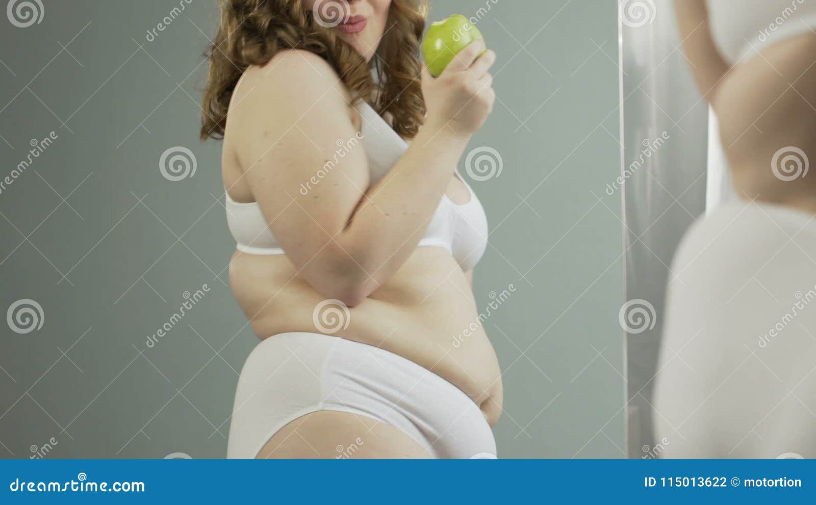 Overweight Woman in Underwear Admiring Her Body in Mirror and