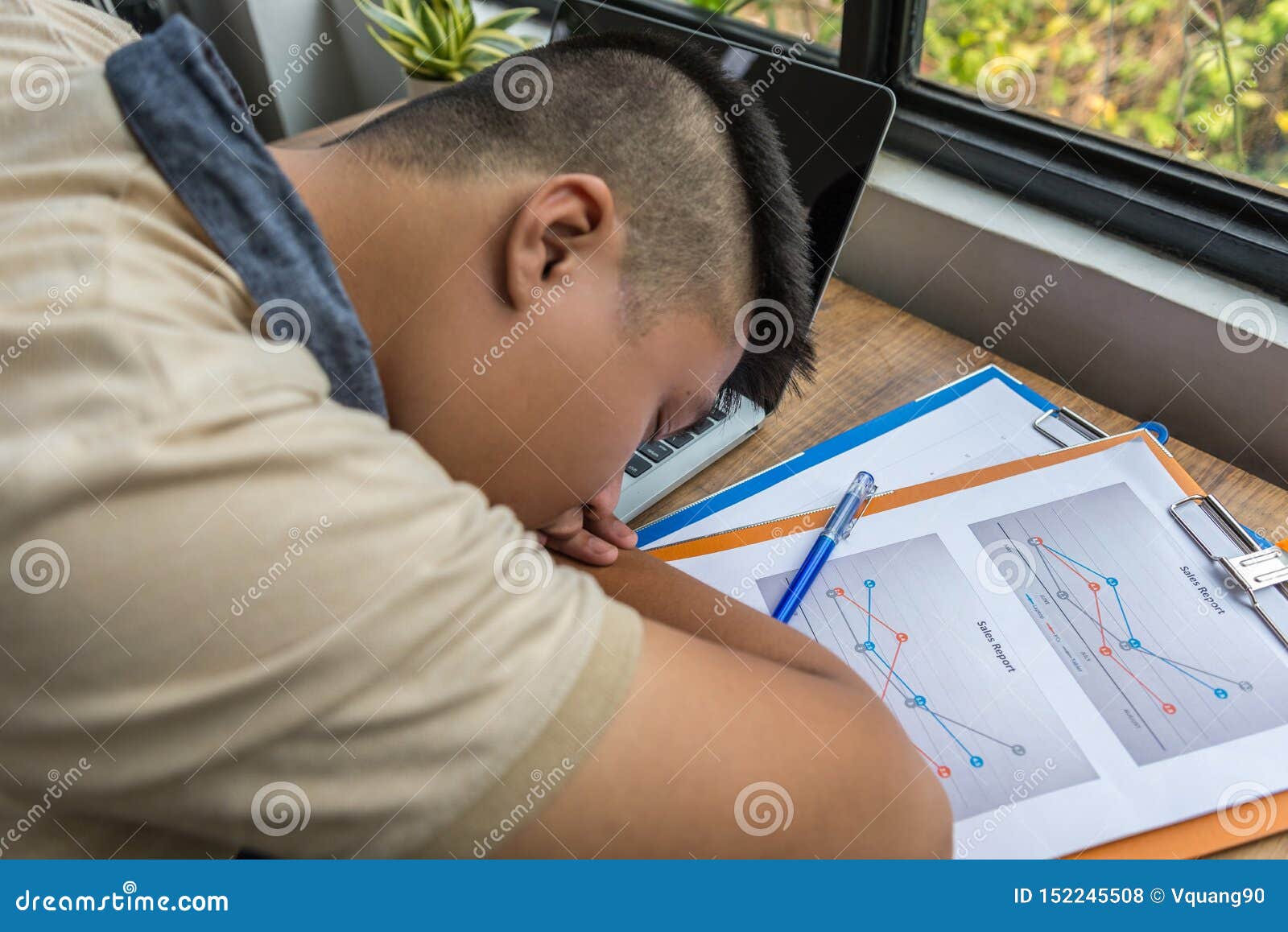 Overworked Asian Man Fall Asleep On Documents On Desk Stock Photo