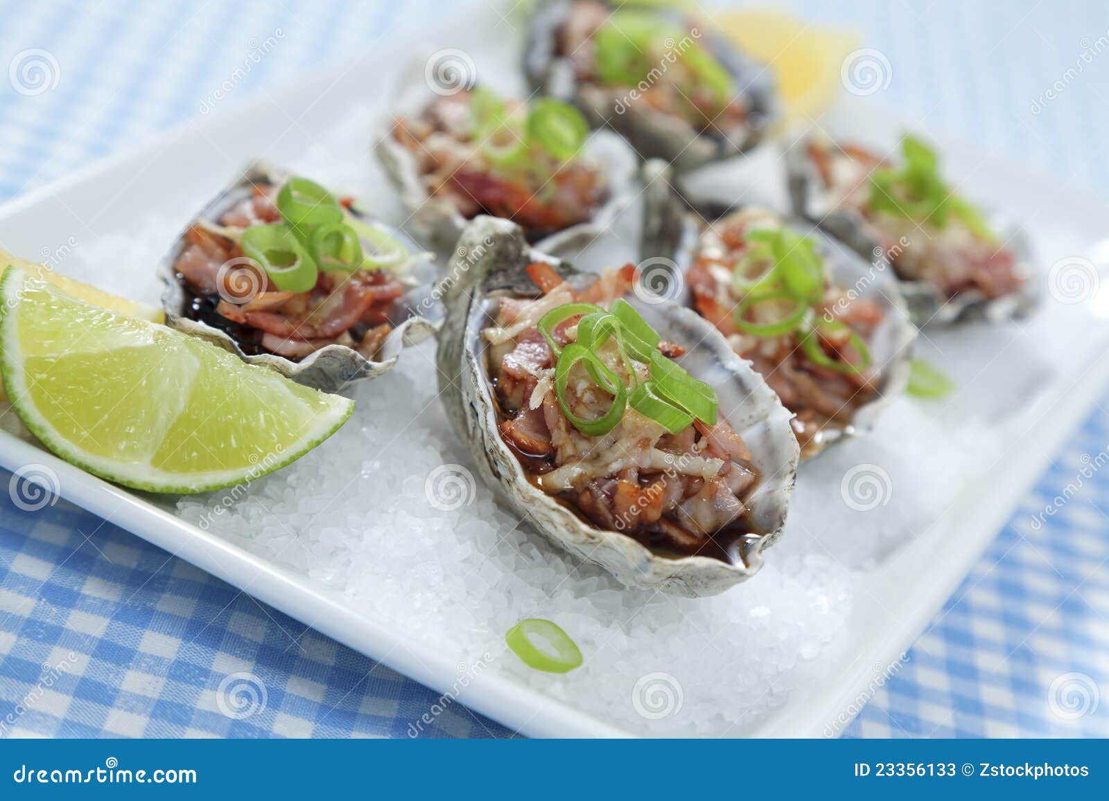Oysters Kilpatrick on blue stock image. Image of entree 23356133