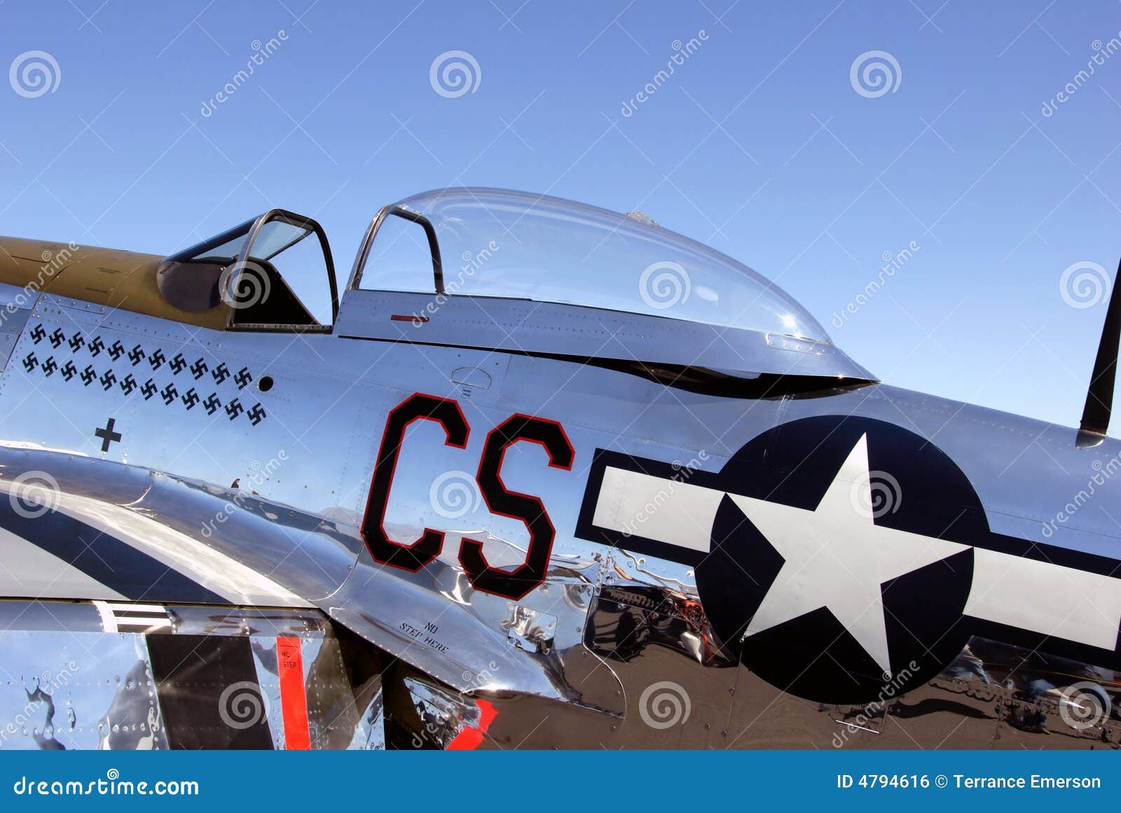 A P51 Mustang fighter plane on display hanging from the ceiling of