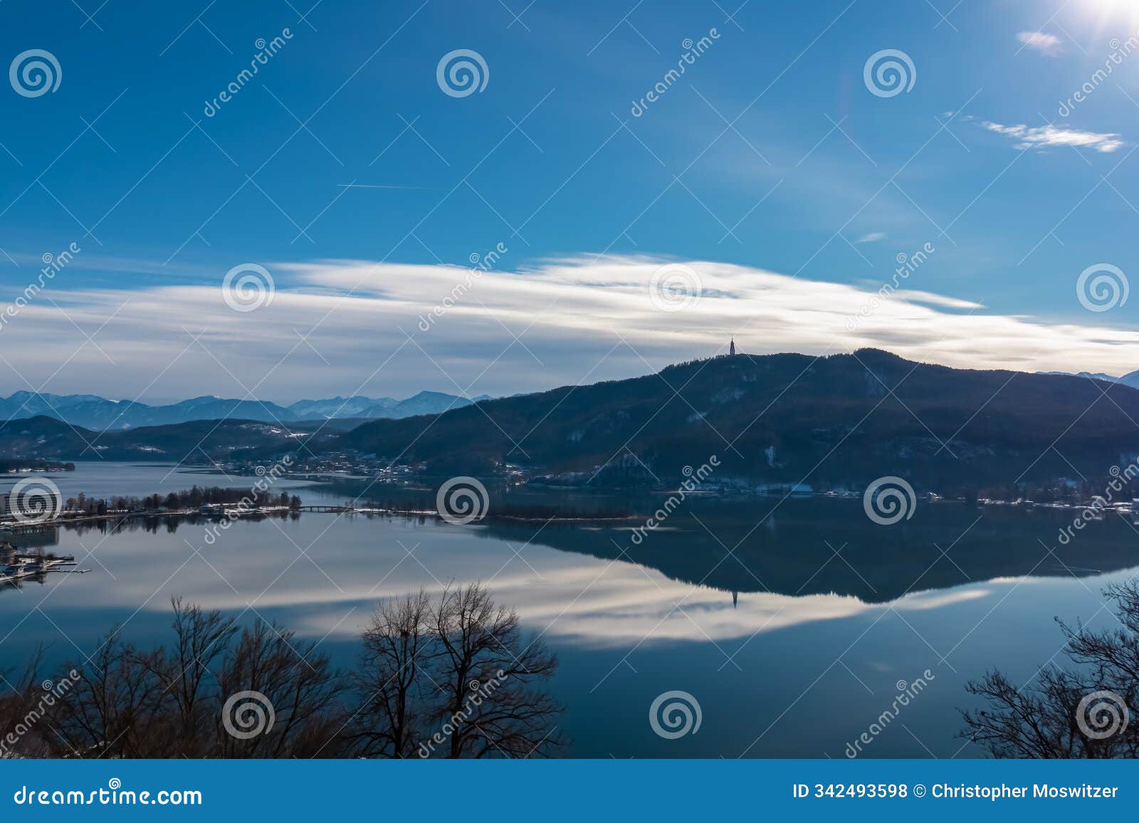pÅ¡rtschach - scenic view of alpine lake wÅ¡rth surrounded by snow-capped mountains karawanks in carinthia