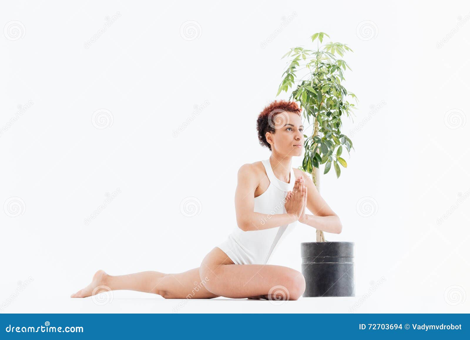 pacified african american young woman sitting and practicing yoga