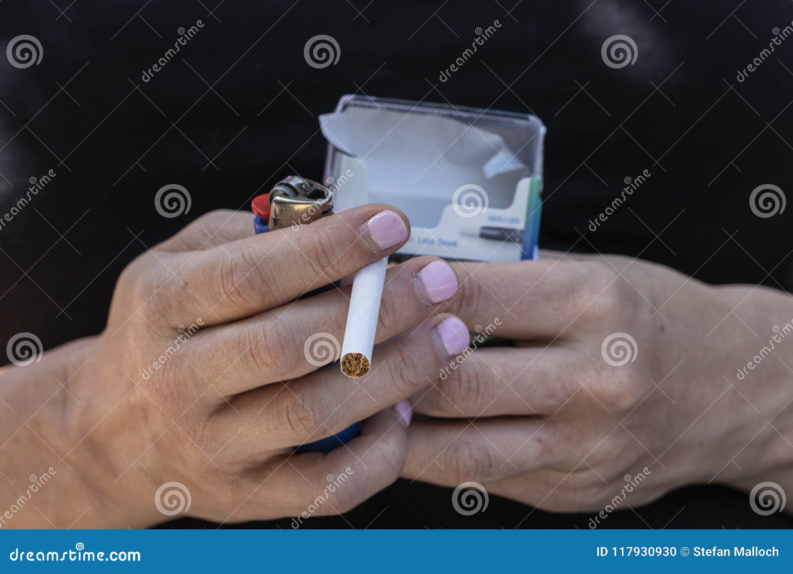 A Pack of Cigarettes and a Lighter in Hands Stock Photo Image of