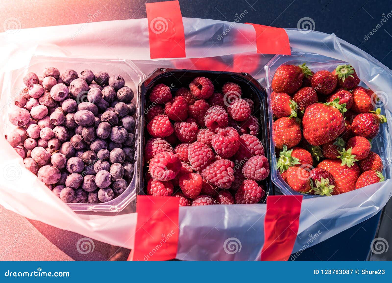 Pack of Tree Different Berries in a Plastic Containers Places in a