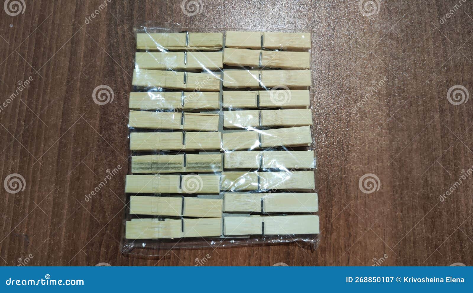 package of wooden white clothespins on a brown wooden surface